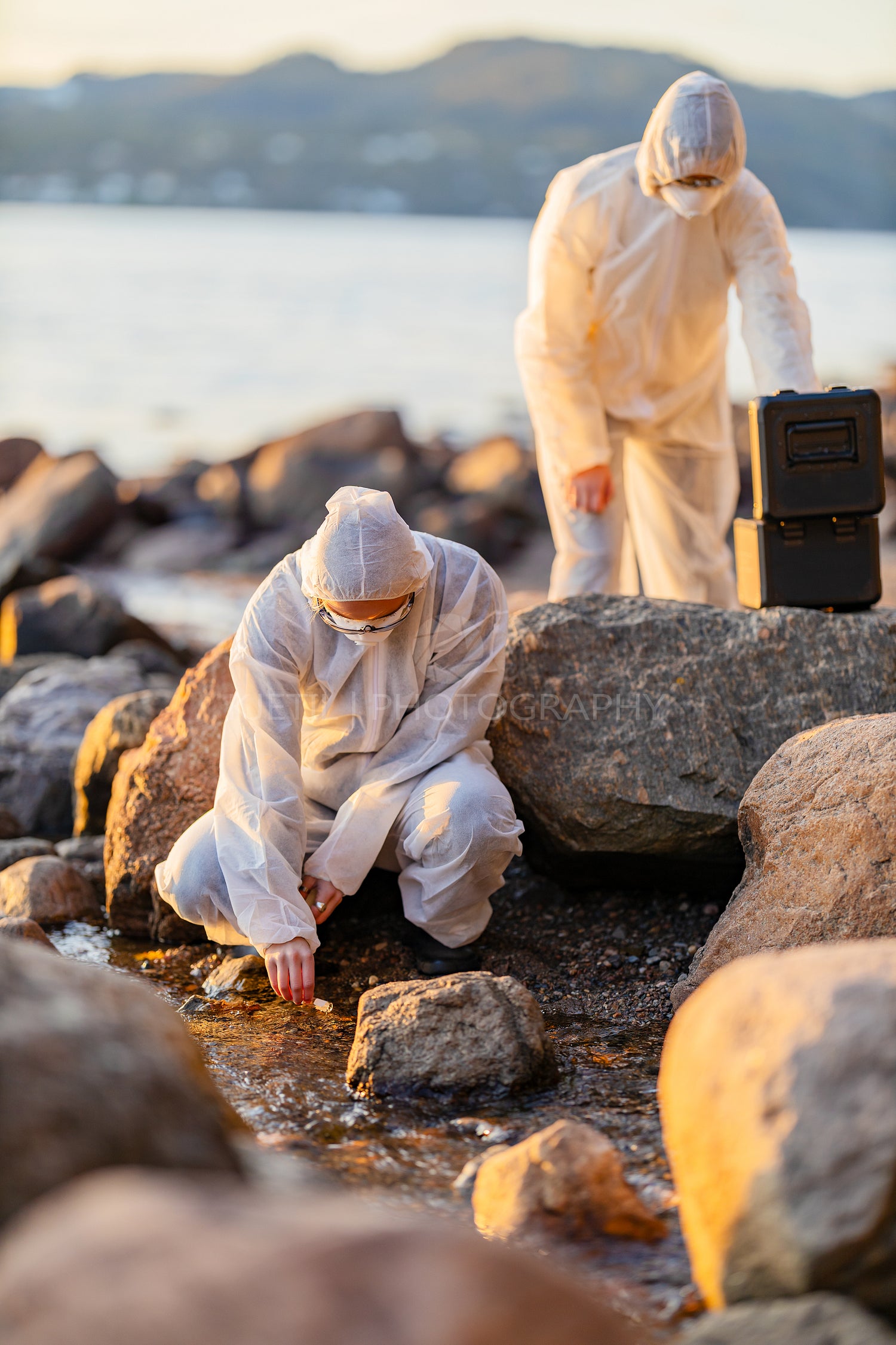 Scientist collecting water sample at the seashore