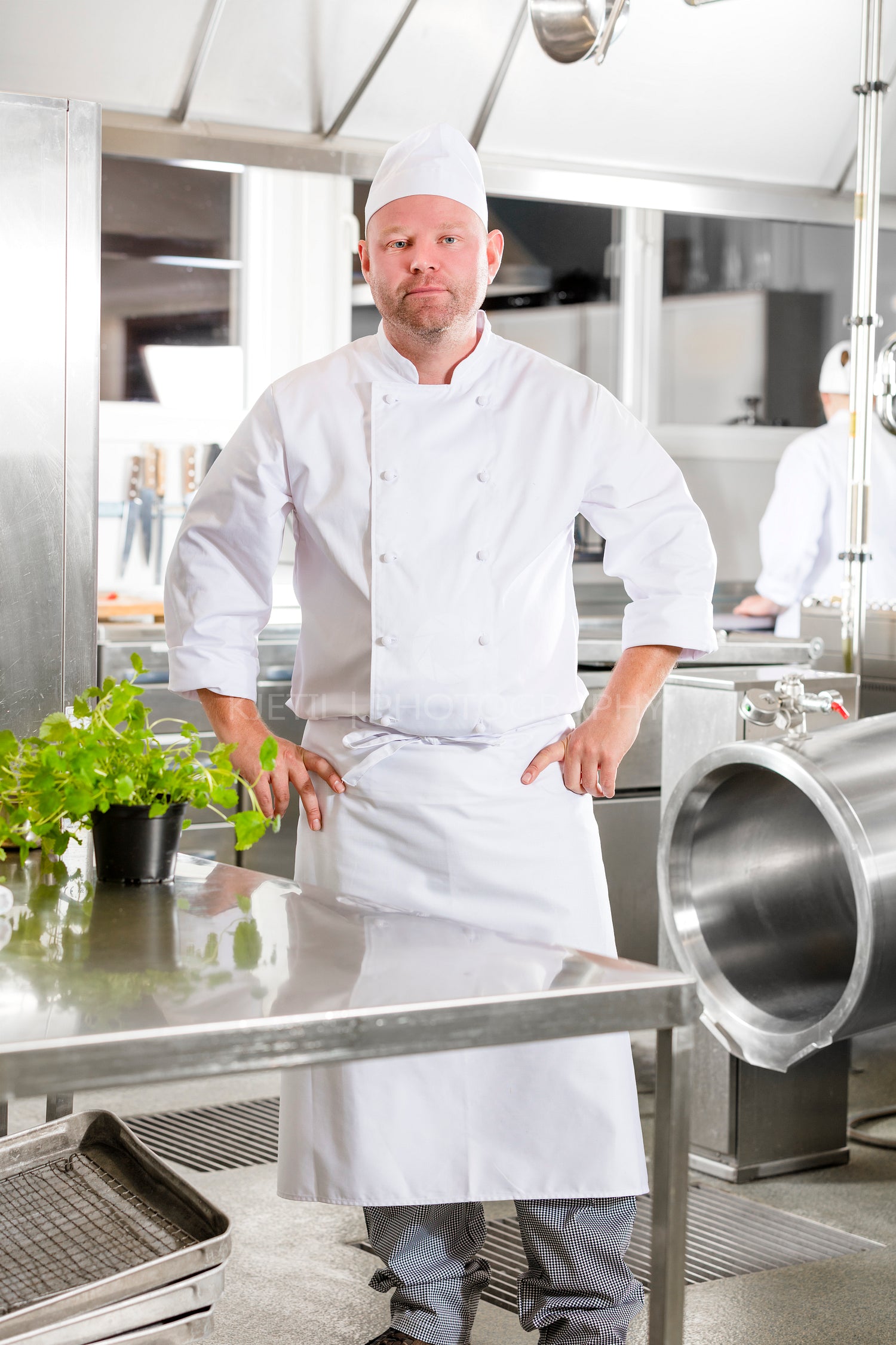 Professional chef standing in large kitchen
