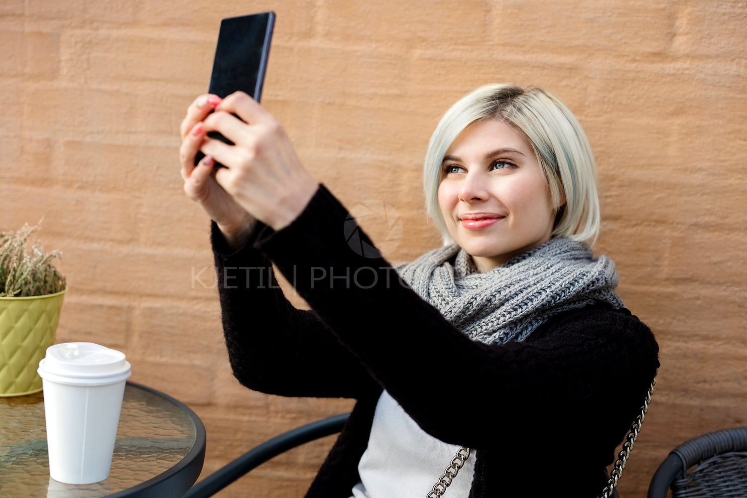 Happy Young Woman Taking Selfie At Sidewalk Cafe