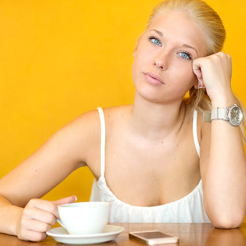 Attractive blonde girl drinking coffee at cafe