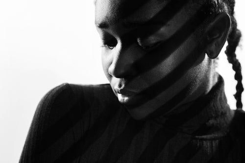 Creative stripes from projection light on beautiful woman with dark skin