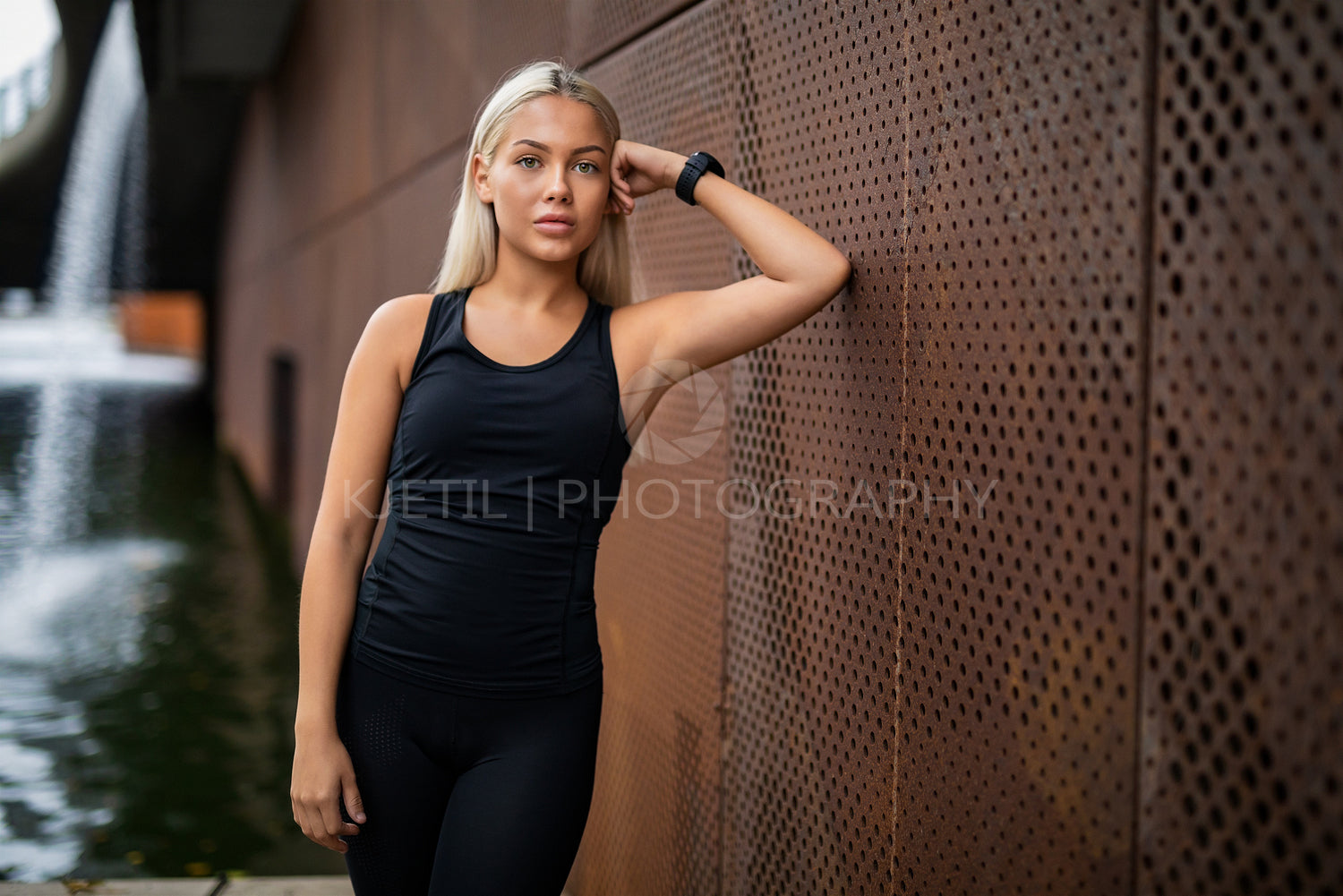 Fit Young Woman Leaning On Metallic Wall After Workout