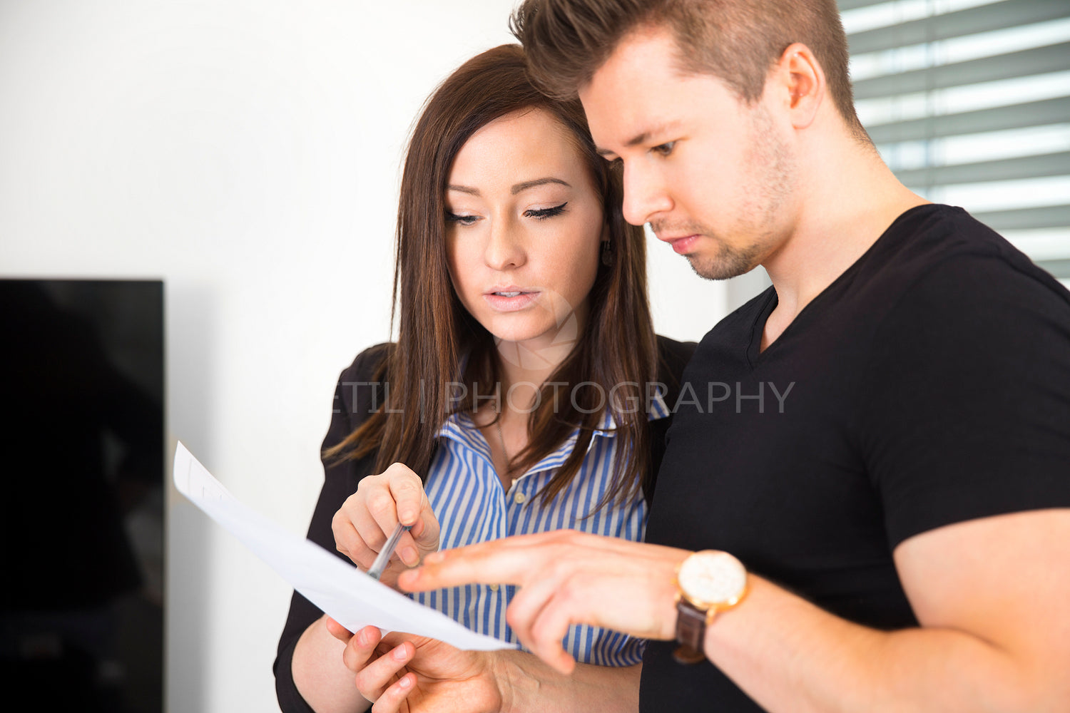 Business People Reading Document In Office