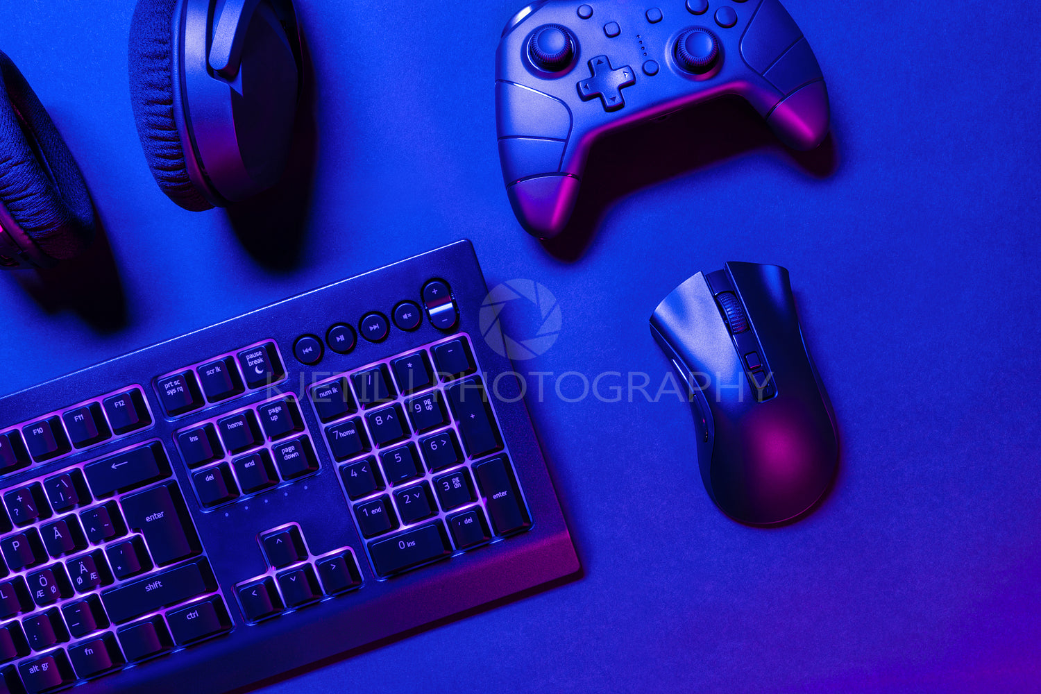 Pink illuminated gaming gadgets on desk