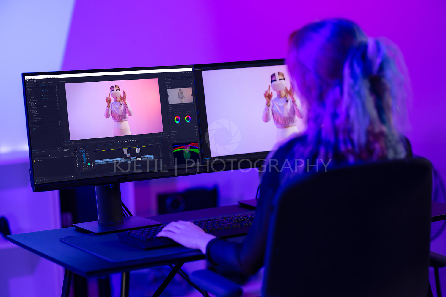 Creative digital artist editing video at work amidst neon lights