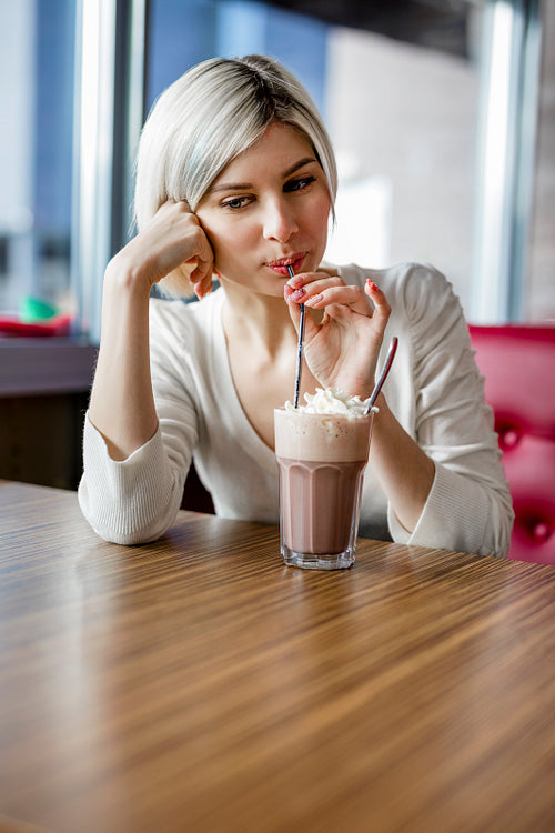Beautiful Woman Drinking Hot Chocolate With Cream In Cafe