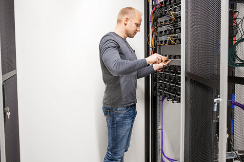 Consultant builds communication rack in datacenter
