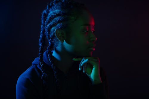 Colorful portrait of thoughtful cool woman with dark skin and braided hair