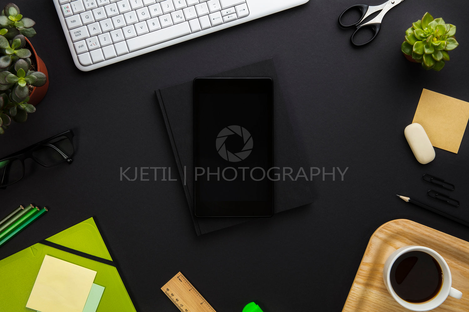 Digital Tablet Surrounded By Office Supplies On Gray Desk