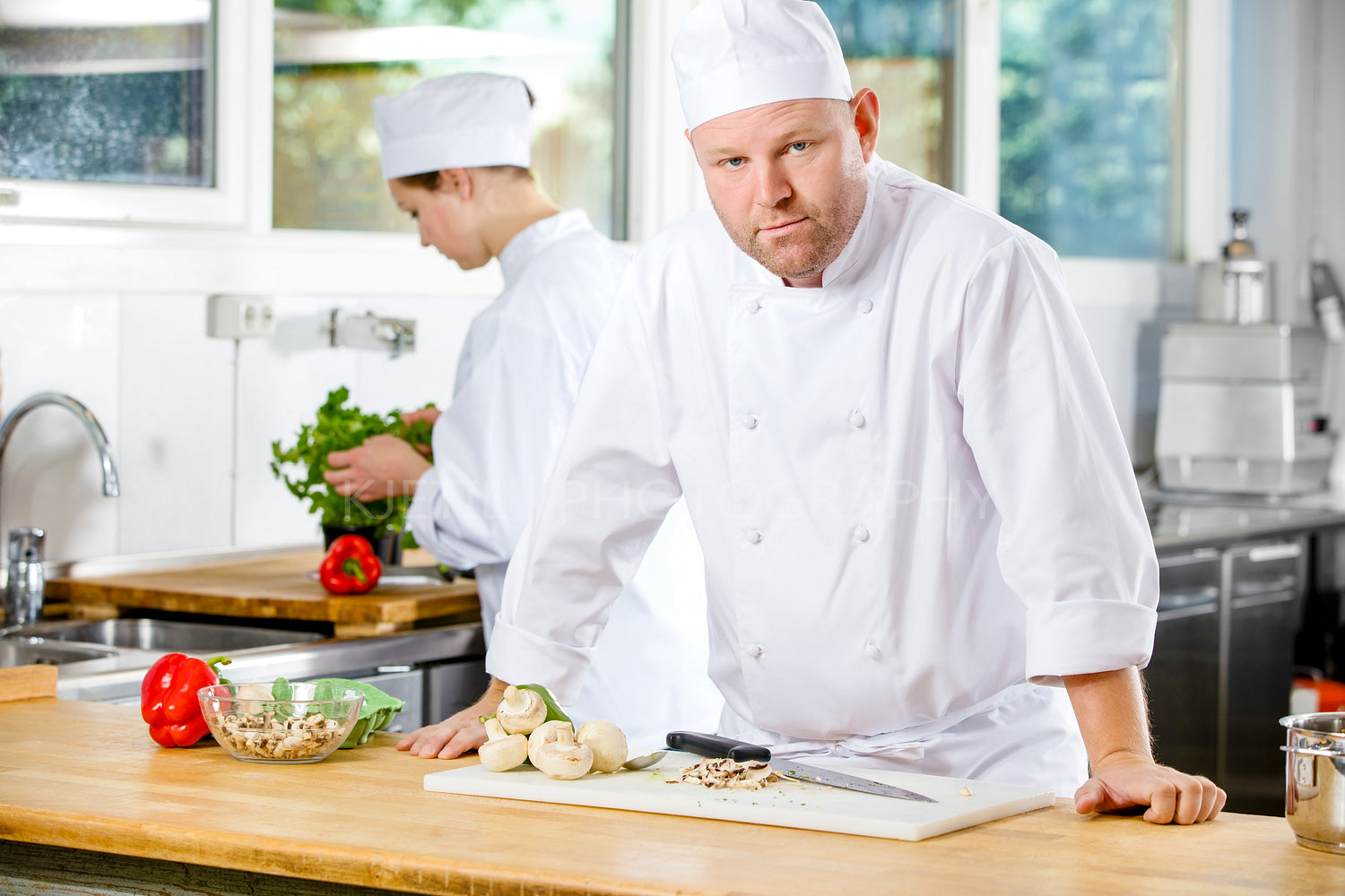 Confident chef making food in large kitchen