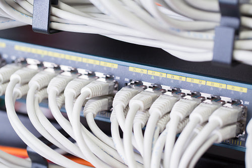 Gigabit network switch with aligned patch cables in datacenter