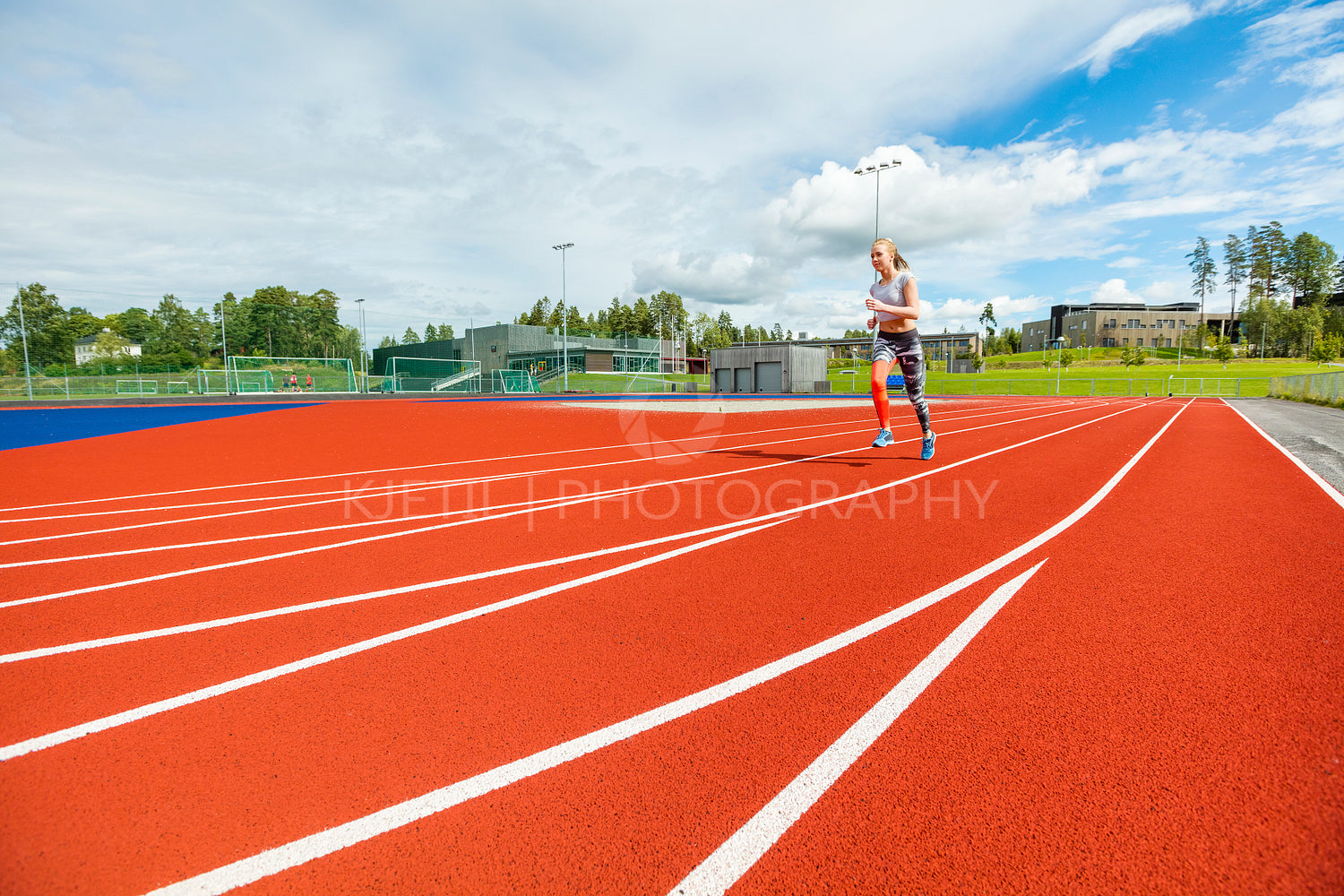 Fit Young Woman Running On Sports Tracks