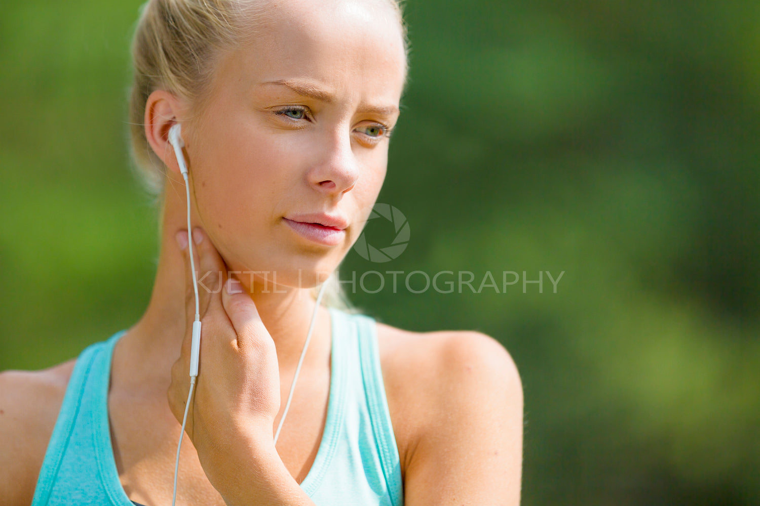 Blonde woman checking her pulse after a long run