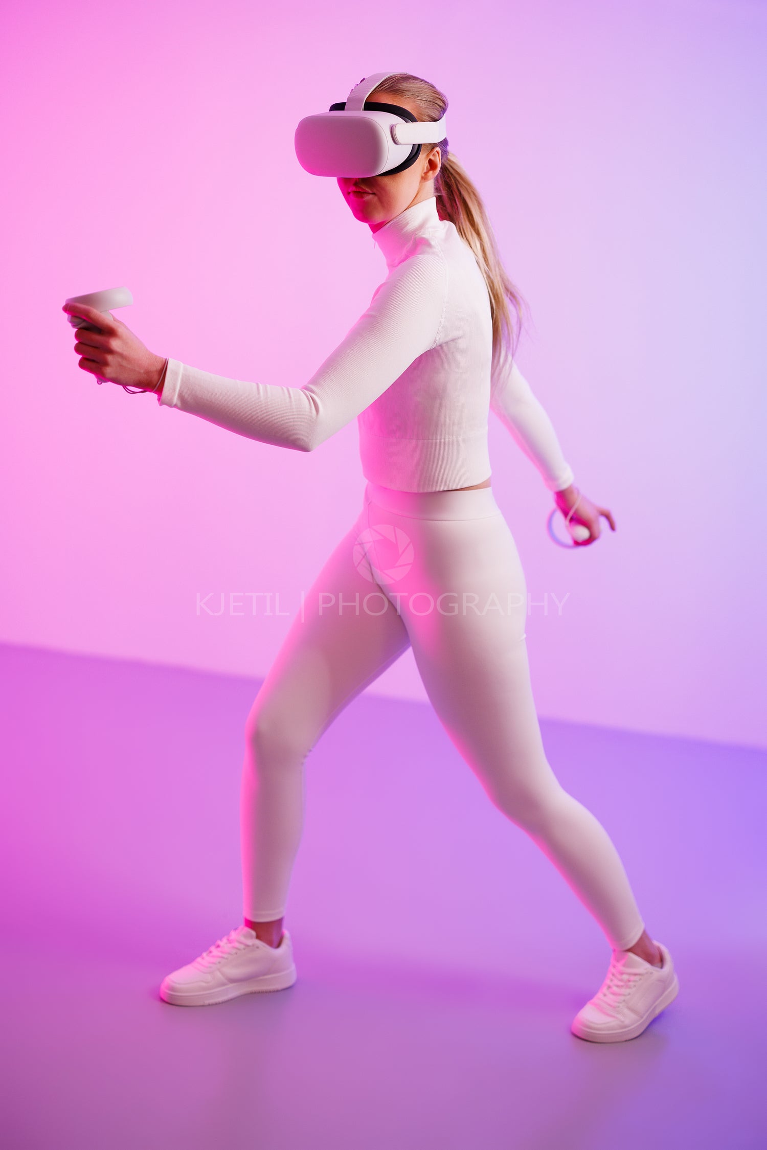 Female in VR glasses against illuminated neon background