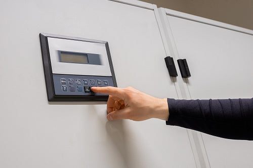Professional Engineer Adjusting Air Conditioner In Datacenter