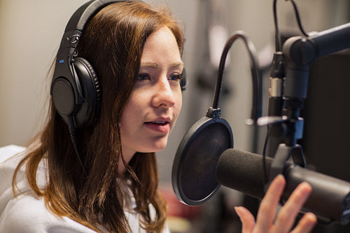 Female Jockey Talking On Microphone In Radio Studio