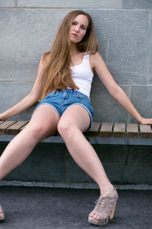 Pretty young woman model on bench