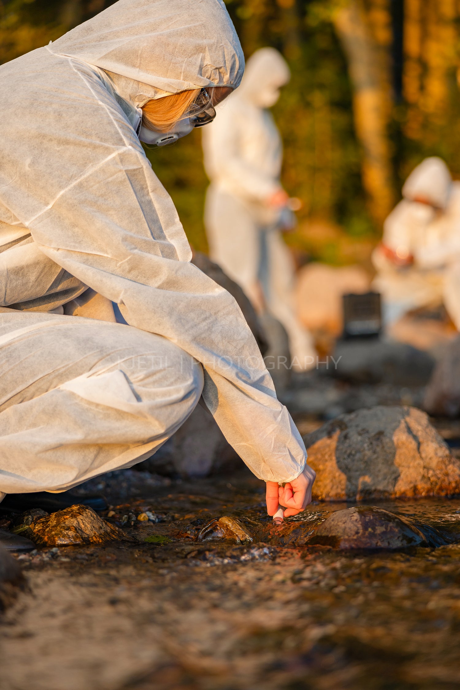 Close-up of female scientist collecting water sample from sea