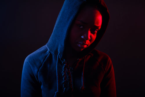 Colorful portrait of thoughtful cool woman with dark skin wearing hoodie
