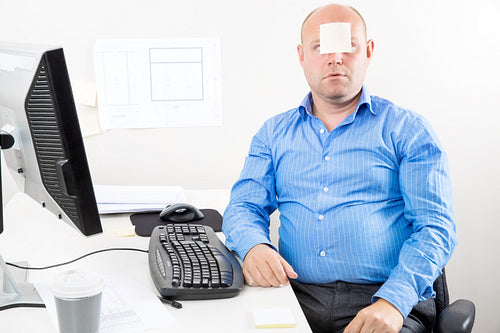 Office worker with note in the face
