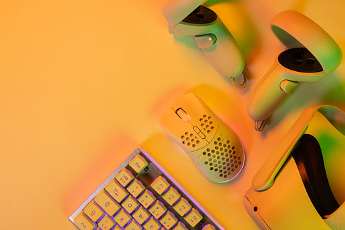 Gaming accessories and keyboard on orange desk
