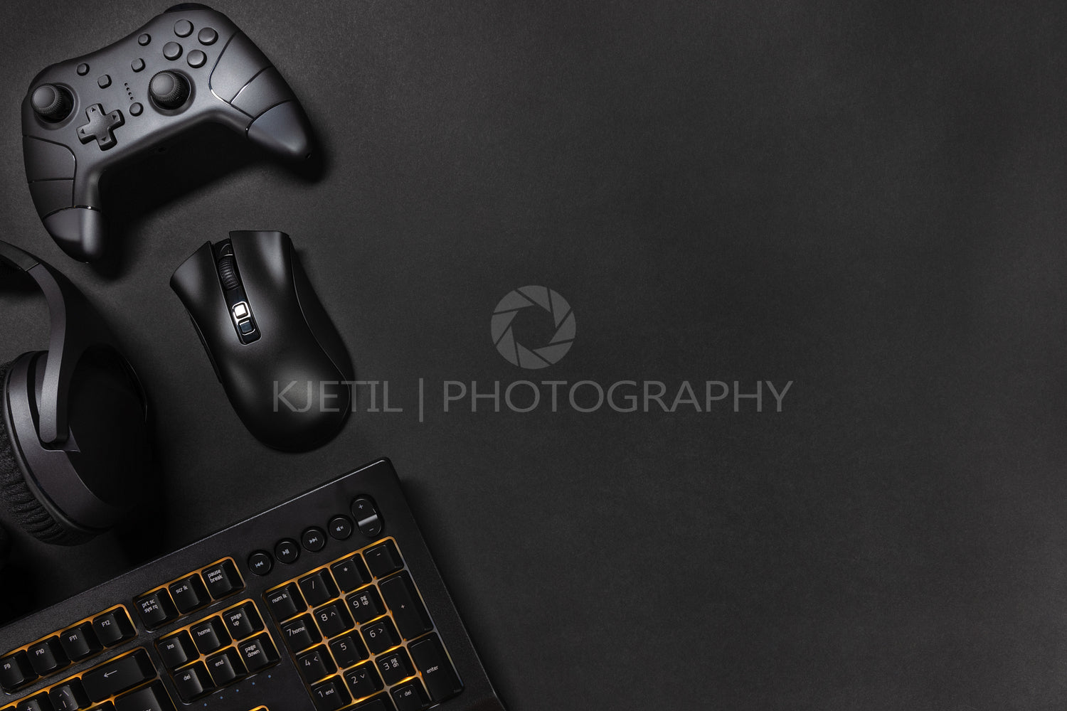 Orange lit keyboard by game controller and mouse