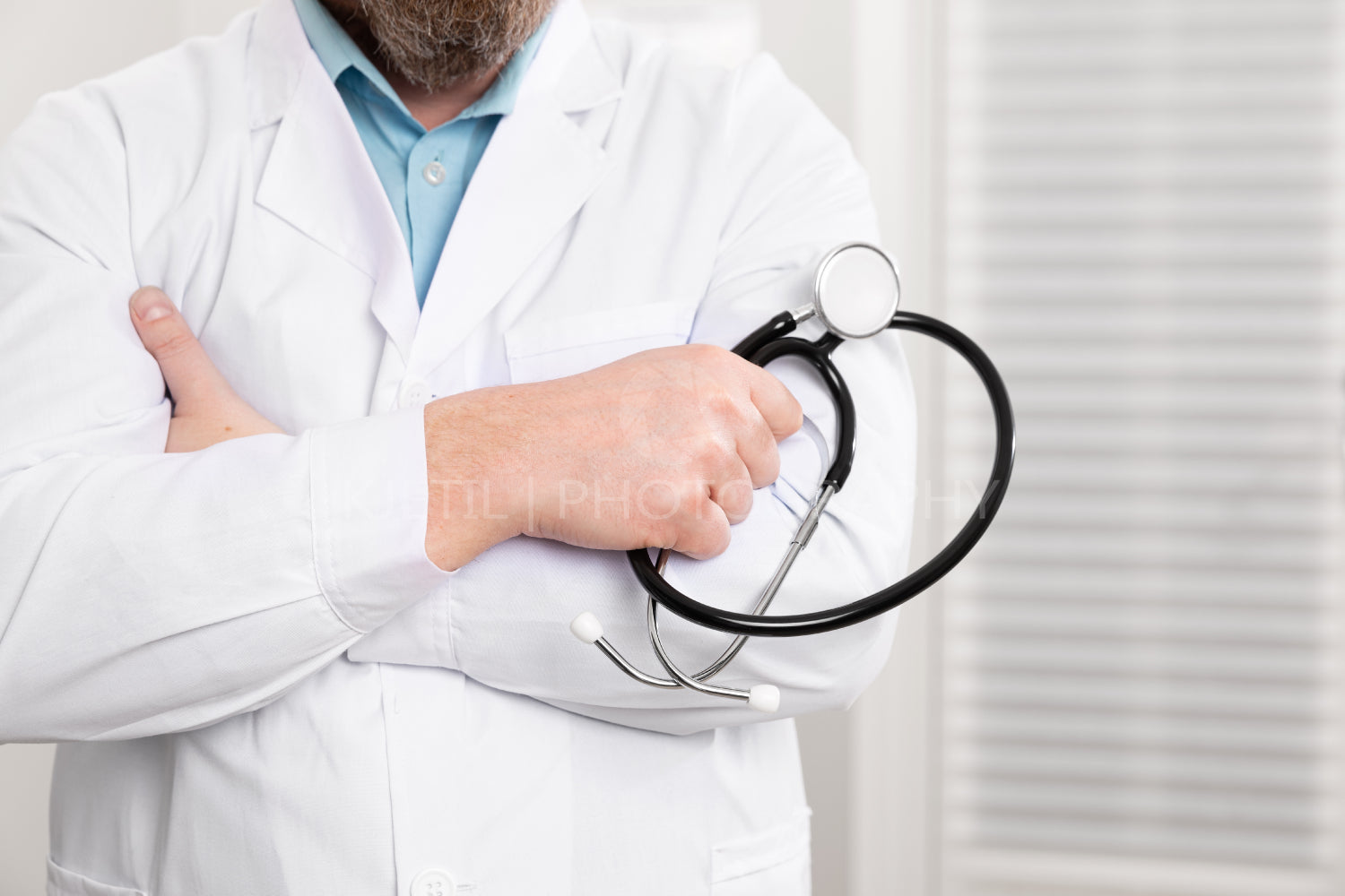 Close-up of a male doctor holding stethoscope in the office