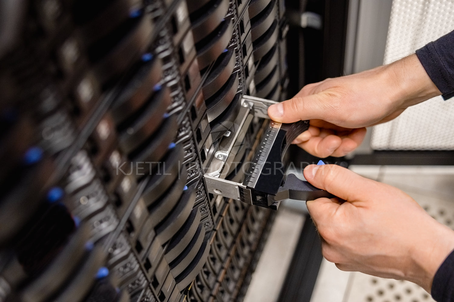 Male Technician Replacing Server Drive At Datacenter