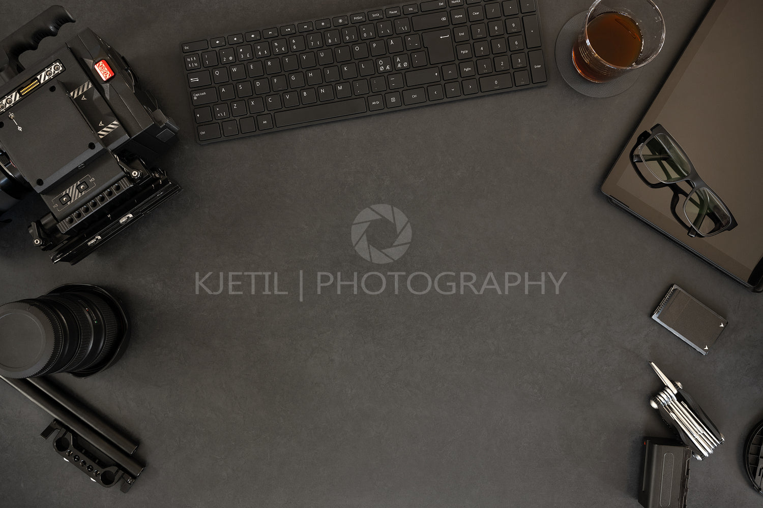 Overhead of digital tablet and filming equipment with coffee on table