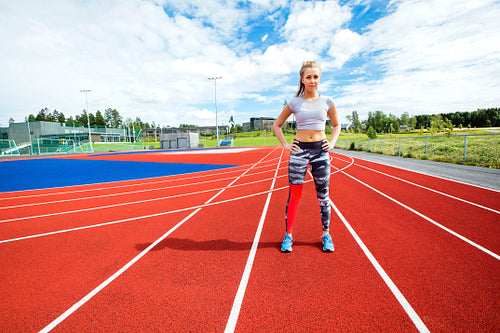 Sporty Woman Standing With Hands on Hips at Running Tracks