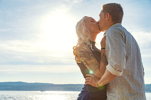 Romantic couple kissing and embrace on beach a sunny day