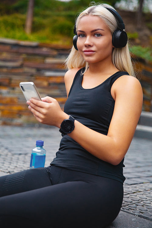 Sporty Woman Listening Music With Headphones And Smartphone