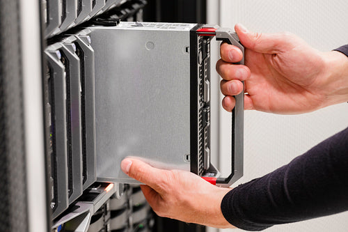IT professional installs server cluster in large datacenter