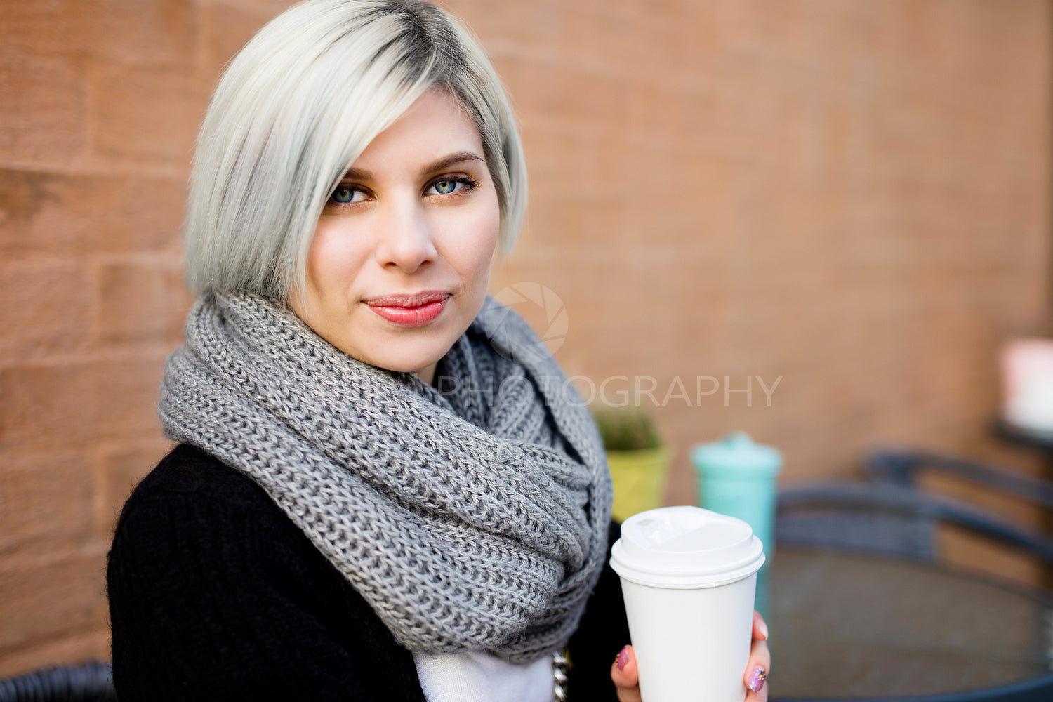 Beautiful Woman Holding Coffee Cup At Sidewalk Cafe