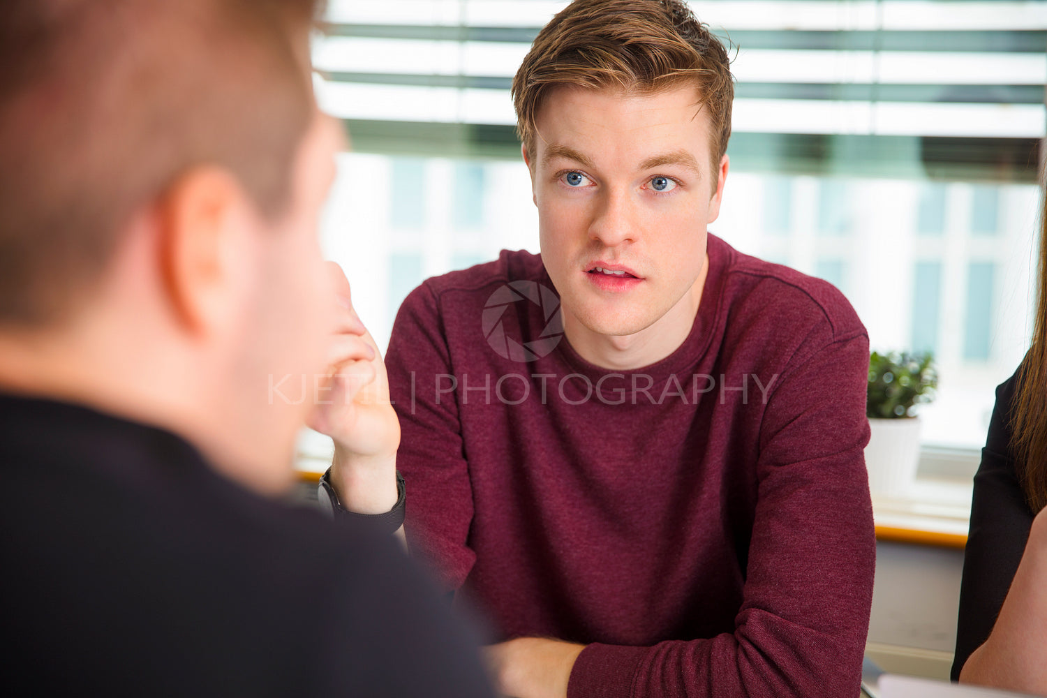 Businessman Looking At Colleague While Communicating In Office