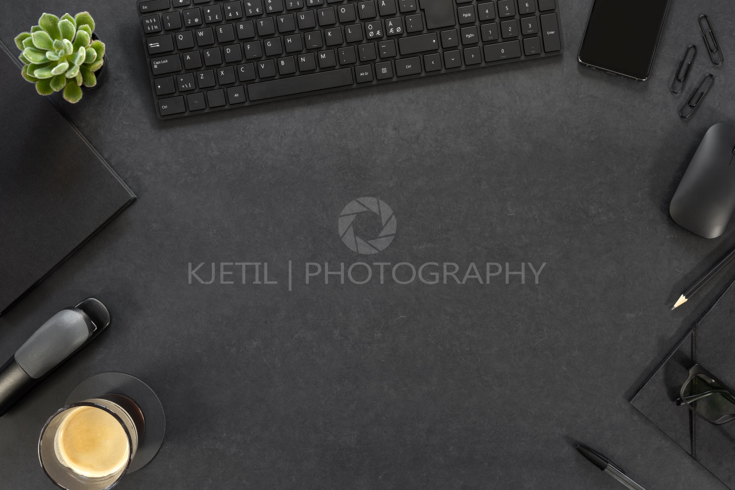 Computer Keyboard With Eyeglasses And Office Supply On Gray Desk