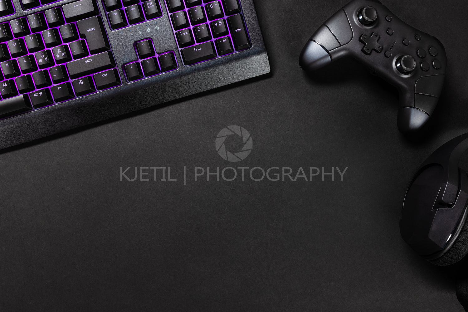 Purple lit keyboard by game controller and mouse