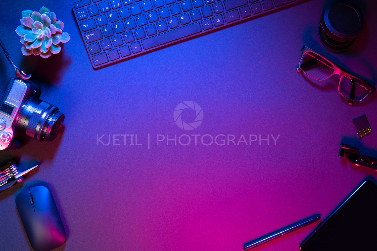 Flat lay of computer parts with camera on illuminated table