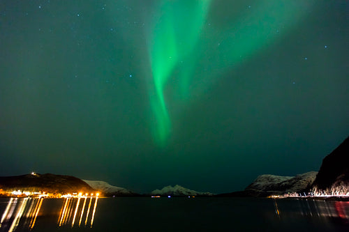 Beautiful northern lights over a fjord at night