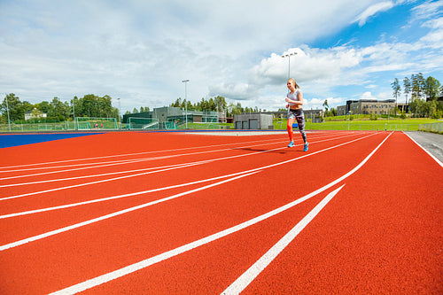 Fit Young Woman Running On Sports Tracks