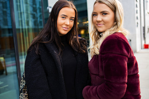 Portrait Of Two Smiling Beautiful Young Women Friends In City