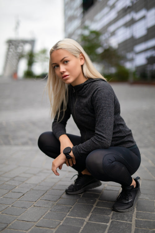 Good Looking Sporty Female Runner With Smartwatch in Modern City Environment