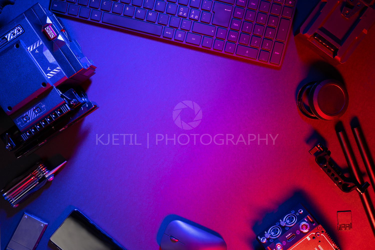 Flat lay of computer parts and video camera on illuminated table