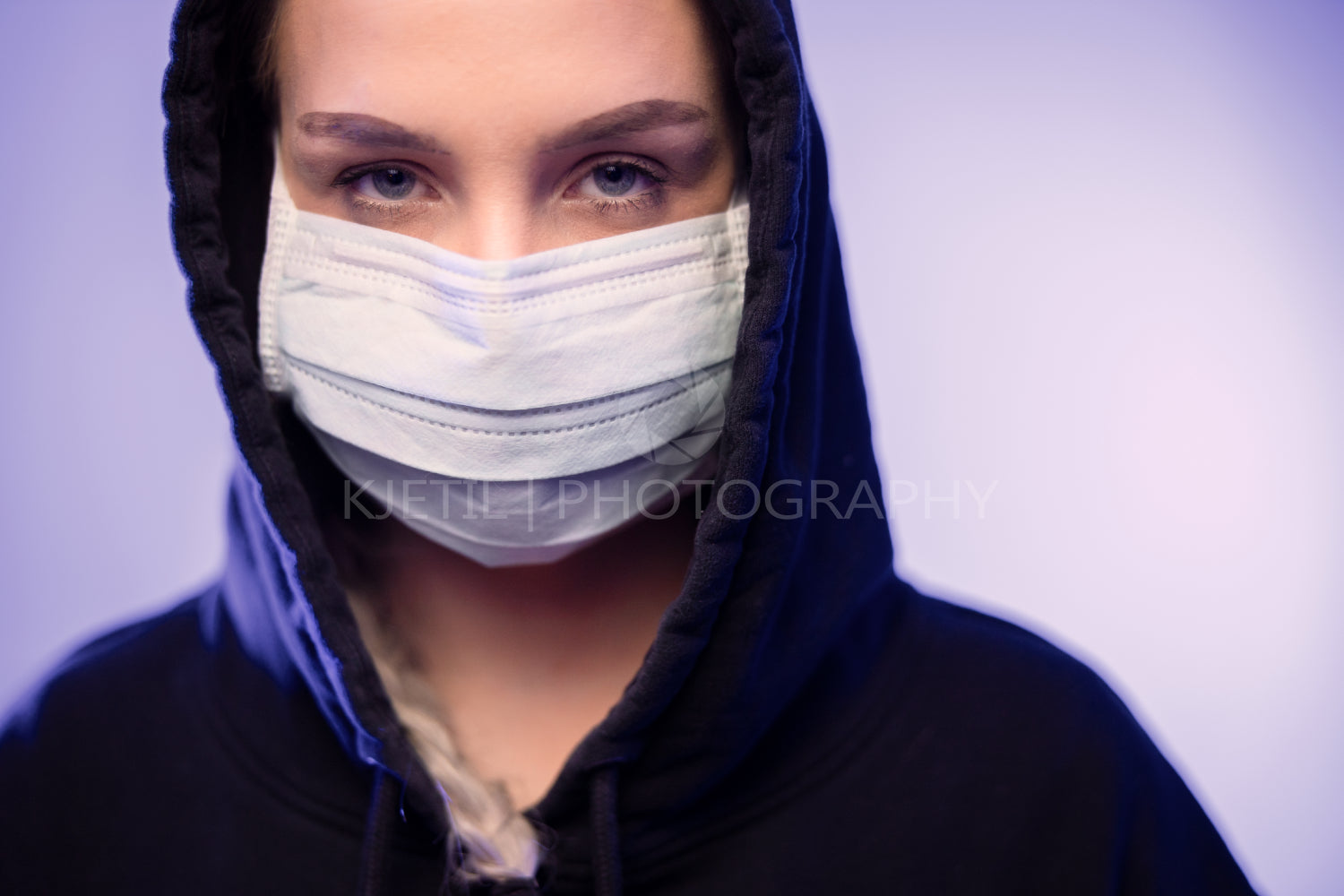 Serious caucasian woman in protective face mask with blue color lights