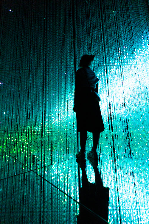 Woman and other people in illuminated virtual multiverse concept