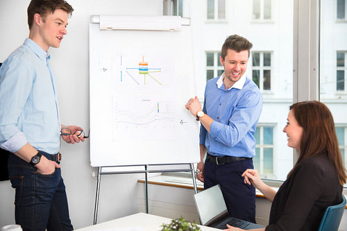 Cheerful Businessmen Looking At Female Colleague In Meeting