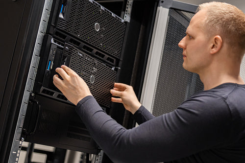 IT Consultant Installing Servers In Large Cloud Datacenter
