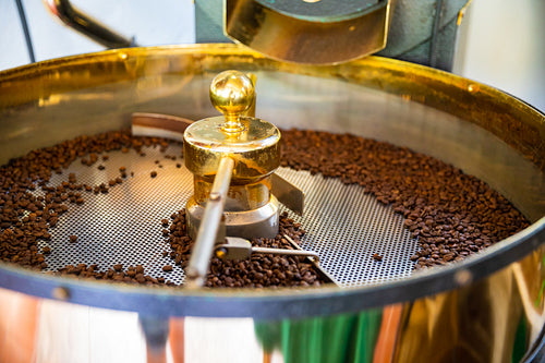 Raw Organic Coffee Beans Roasting In Machine