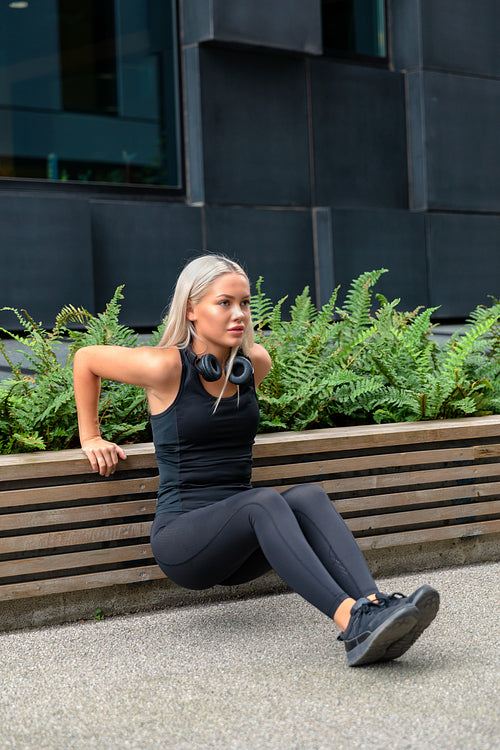 Dedicated Woman Doing Triceps Dips Outdoor in the City