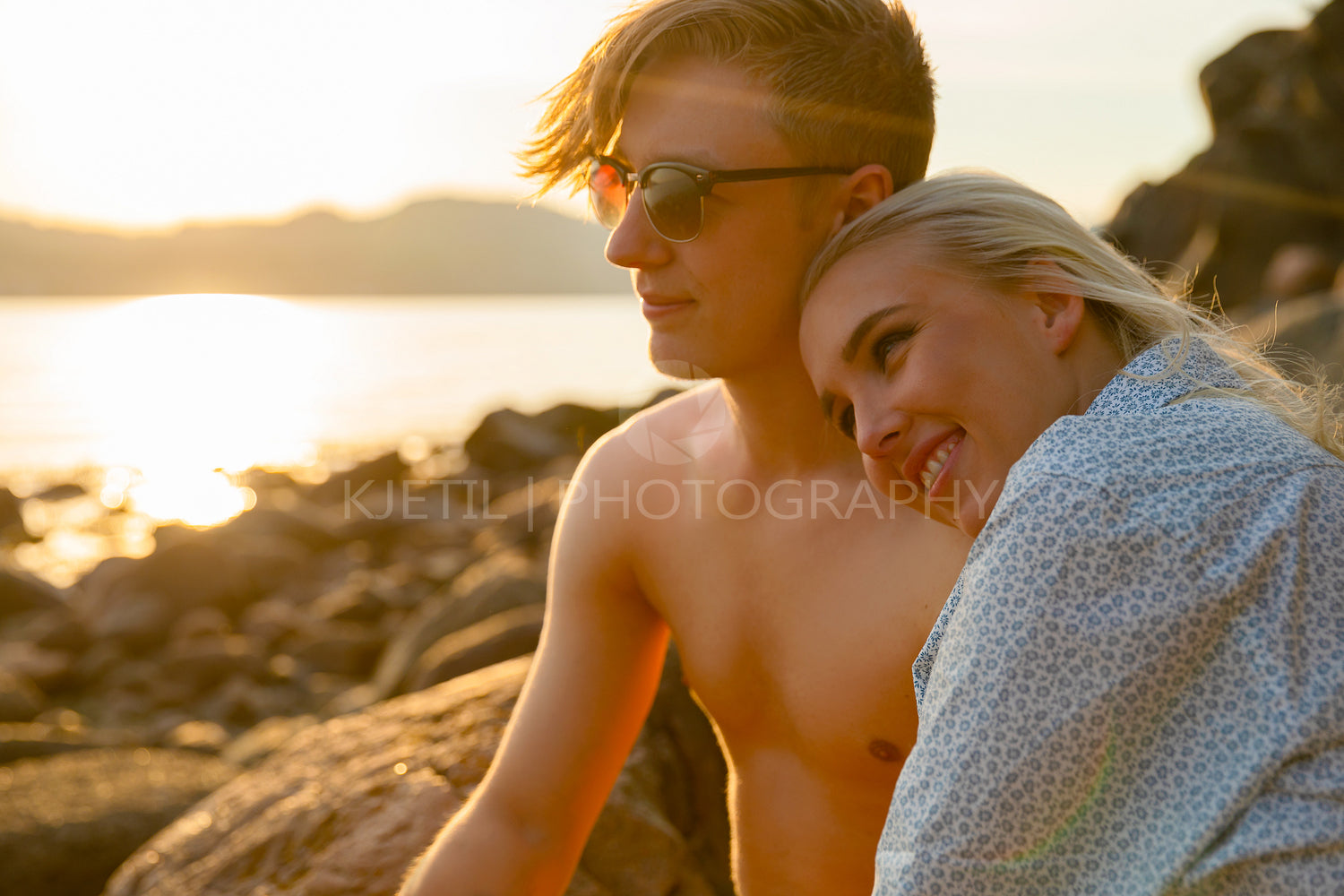 Smiling Woman Sitting With Boyfriend At Beach